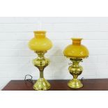 Two brass oil lamp style table lamps with amber coloured glass shades, (2)