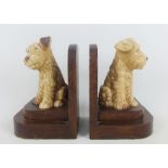 A pair of Sylvac pottery dog bookends, on wooden stands, height overall 16cm (2)