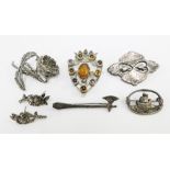 Mixed lot to include a hard stone shield brooch, three silver brooches and a marquisette brooch