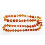 A vintage strand of faceted amber coloured beads, 60cm long