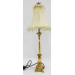 A contemporary faux gilt wood table lamp base and shade