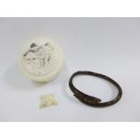 Early 20th century circular ivory box with a tigers head pattern to the lid, 7cm diameter,