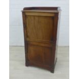 Mahogany cabinet with a three quarter gallery top, panelled doors and shelved interior, 98 x 51cm