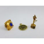 18ct gold pendant with coloured cabochons, a 9ct gold 'street lamp' charm and a yellow metal and