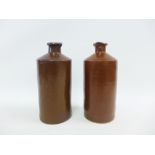 A pair of brown salt glazed gin flasks, 24cm high (2)