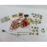 A large collection of costume jewellery to include, pendant necklaces, beads, brooches, hat pins an