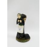 Coll Pottery female figure, modelled standing with a peat basket on her bag, 22cm high
