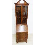 Mahogany veneered bureau bookcase with a broken swan neck pediment over a pair of glazed cupboards