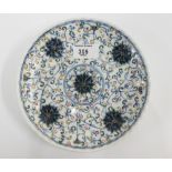 Chinese saucer dish of circular lobed form, in a five colour palette depicting flowers and scrolling