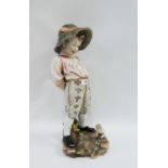 Continental porcelain figure of a boy, modelled standing with a flower fairy at his feet, the base