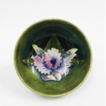 Moorcroft green glazed bowl tubeline decorated with Orchids, bearing impressed facsimile signature