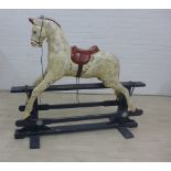 Dapple rocking horse on a black wooden trestle base, 112 x 132cm