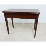 Mahogany fold over table on square tapering legs, 76 x 42cm