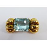 Unmarked gold brooch claw set with a baguette cut gemstone, 4cm