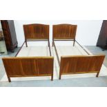 Pair of Gordon Russell three fielded panel walnut beds, on chamfered supports, complete with side