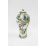 Chinese Famille Verte baluster vase and cover, painted with figures, the lid with losses, 26cm high