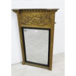 Giltwood wall mirror, the inverted breakfront top with ball finials above a leaf carved frieze, with