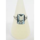 18ct white gold aquamarine and diamond cocktail ring, the central emerald cut aquamarine flanked
