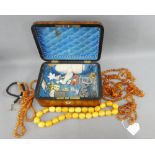 Walnut box containing amber beads, costume jewellery and faux amber butterscotch coloured beads (a