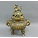 Chinese bronze censor, the pierced cover with a temple lion finial, on three paw feet, 19cm high