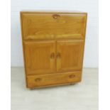 Ercol Golden Dawn, Windsor range bureau cabinet with a fall front over a pair of cupboard doors,