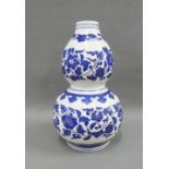 Chinese blue and white double gourd vase painted with flowers and foliage within ruyi borders,