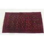 Eastern rug with red field with geometric motifs and flowerhead border, 103 x 195cm