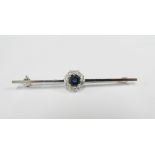 18ct white gold brooch claw set with a central diamond within a surround of ten bright cut diamonds,