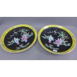 Pair of Chinese chargers, the black ground painted with figures within a yellow border, 40cm