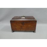 19th century mahogany sarcophagus tea caddy, the hinged lid opening to reveal three division, on bun