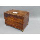 19th century mahogany and inlaid tea caddy with hinged lid and two divisions, on four brass bun