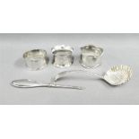 Three early 20th century silver napkin rings, silver handled nail file and a Sheffield silver sifter