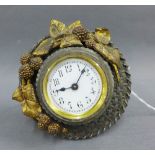 Bedside clock with white metal basket weave and gilt leaf frame, with a strut back, size overall