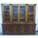 19th century mahogany breakfront bookcase cabinet, with four glazed doors, shelved interior and four