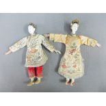 Two Japanese dolls with painted pottery heads and wearing hand stitched traditional costume, 26cm