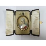 Double locket pendant containing a portrait miniature, signed Hall, of an 18th century female with