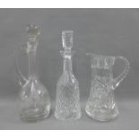 Two glass decanters and stoppers and a water jug (3)