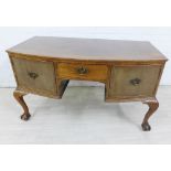 Mahogany bow front sideboard with three drawers and cabriole legs terminating on claw and ball feet,