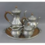 Pewter tea and coffee set, with wooden handles and a wooden oval tray (5)
