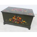 Green painted wooden trunk with handpainted floral sprays, with lift up hinged top and iron