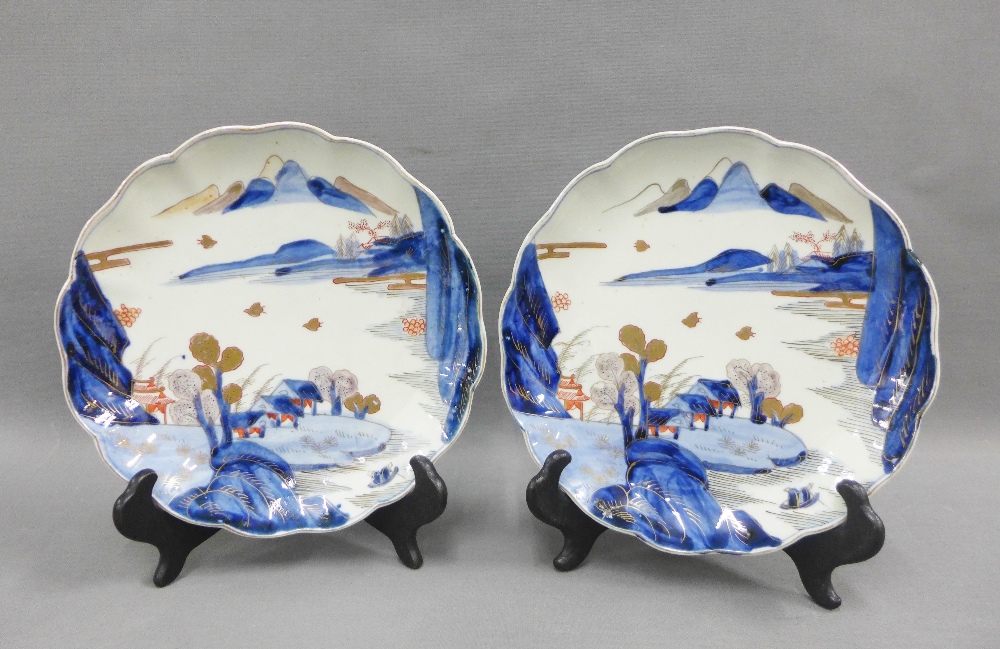 Pair of Chinese blue and white plates, with crimped rims and painted with a village landscape