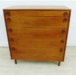 Meredew mid century teak chest, with five graduated long drawers and oval teak handles, on turned