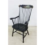 Ebonised wooden Windsor style armchair with floral painted top rail, spindle back, solid seat and