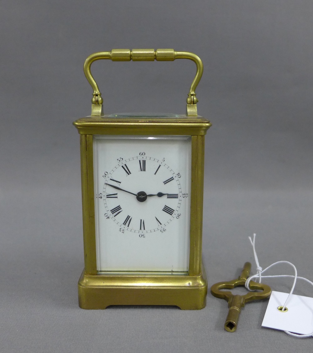 French brass and glass panelled carriage clock of small proportions, the enamel dial with Roman hour