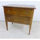 Mahogany chest, the rectangular top over two long drawers, on square tapering legs with brass