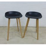 Hay bar stools with black sloping seats, light wood legs and metal stretchers, 75 x 44cm, (2)