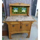 Arts & Crafts oak washstand with stylised tiled back over a marble top with towel rails to each