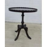 Modern mahogany side table, with oval top and wavy rim, on quadraped legs, 56 x 48cm