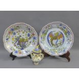 Two faience plates together with small Italian lidded jar, the over with a bird finial (3)