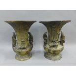 A pair of chinoiserie bronze flared rim vases surmounted by figures and water buffalo, 18cm high (2)